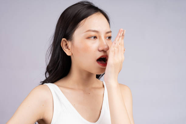 a woman smelling her breath