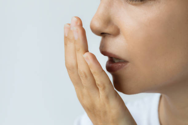 a woman trying to smile her breath