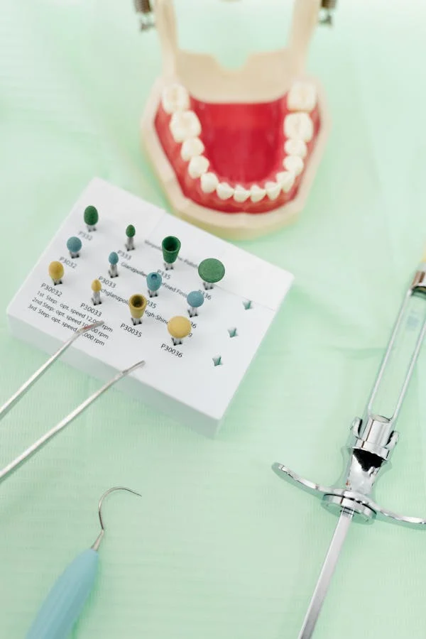dental model with dental tools on a mint green surface